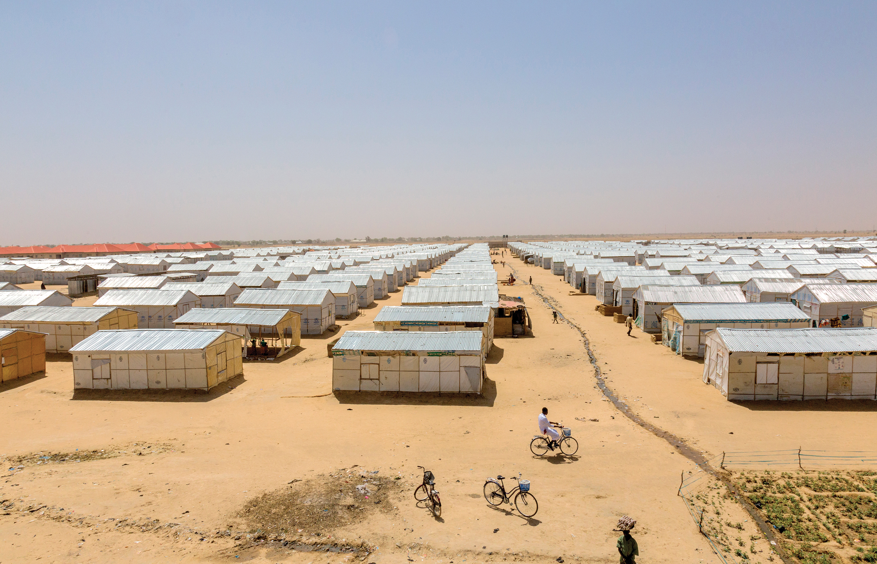 : An estimated 1.1 million internally displaced people live in the Borno state capital, Maiduguri, including 21,000 in the Bakasi IDP camp. An overview image of the Bakasi IDP camp showing rows of tents.